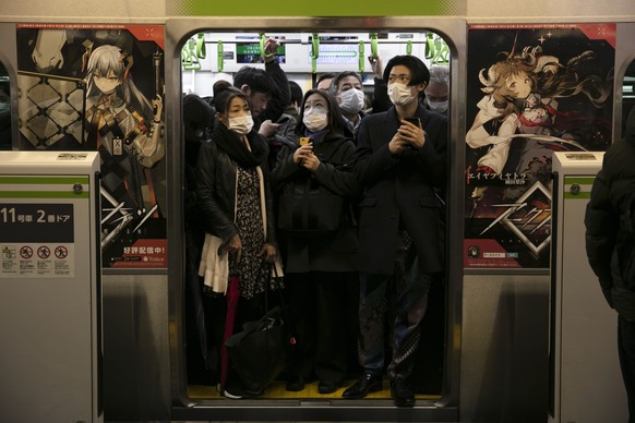 Commuters wearing masks stand in a packed train at the Shinagawa Station in Tokyo, Monday, March 2, 2020. Coronavirus has spread to more than 60 countries, and more than 3,000 people have died from th ...