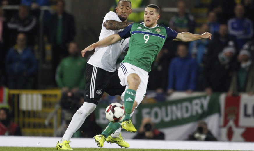 Germany&#039;s Jerome Boateng, left, competes for the ball with Northern Ireland&#039;s Conor Washington during the World Cup Group C qualifying soccer match between Northern Ireland and Germany at Wi ...