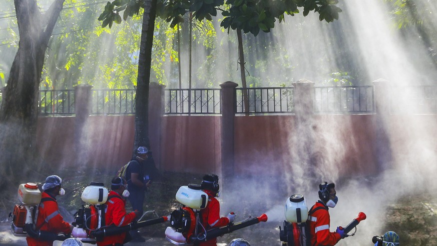 epa08327953 City Hall health officials wearing protective suits disinfect the entrance of Sri Petaling mosque in Kuala Lumpur, Malaysia, 28 March 2020. According to Malaysia?s Health Director-General  ...