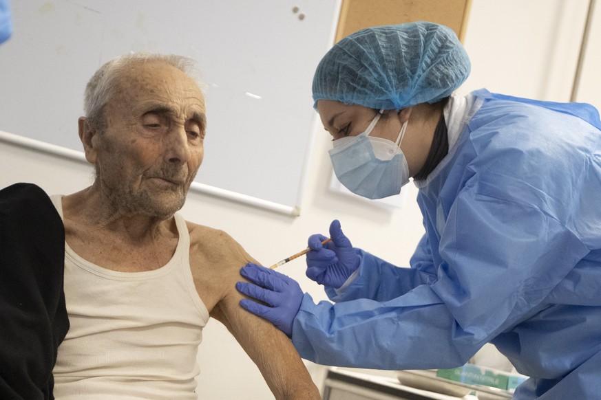 Luigi Monte receives the COVID-19 vaccine at the Don Orione rest home in Rome, Saturday, Jan. 2, 2021. Elderly at Don Orione rest home received the COVID-19 vaccine Saturday in Rome, in a second round ...