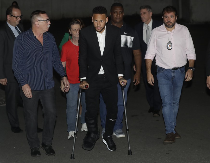 Using crutches because of an injured right ankle, Brazil&#039;s soccer player Neymar leaves a police station where he answered questions about rape allegations against him in Sao Paulo, Brazil, Thursd ...