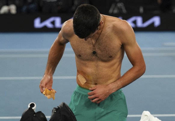 Serbia&#039;s Novak Djokovic takes a bandage off after defeating Russia&#039;s Daniil Medvedev in the men&#039;s singles final at the Australian Open tennis championship in Melbourne, Australia, Sunda ...