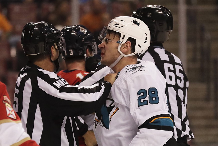 A referee grabs San Jose Sharks right wing Timo Meier after Meier was fighting with Florida Panthers defenseman Mark Pysyk during the first period of an NHL hockey game, Monday, Jan. 21, 2019, in Sunr ...