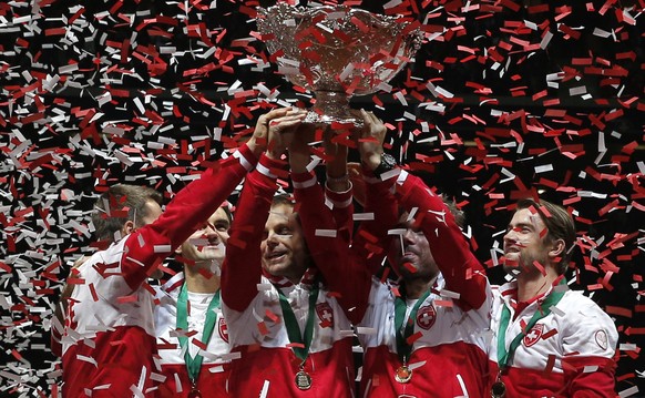 Swiss players celebrate with the cup after defeating France in the Davis Cup final at the Pierre Mauroy stadium in Lille, northern France, Sunday, Nov. 23, 2014. Switzerland won 3-1 and wins the Davis ...