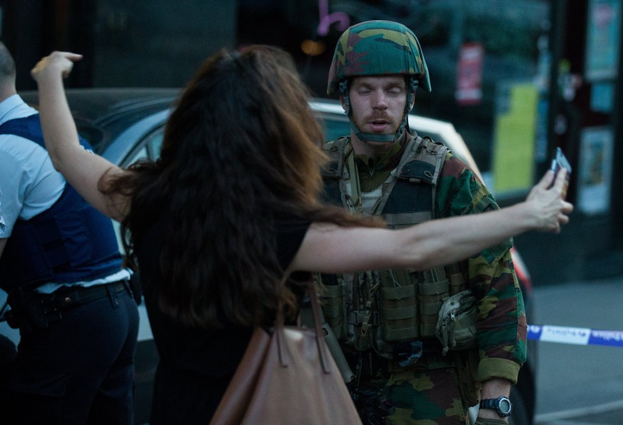 epa06039903 A Belgian soldier searches a woman during the evacuation at the Brussels Central Station after a neutralized terrorist attack attempt, in Brussels, Belgium, 20 June 2017. According to Belg ...