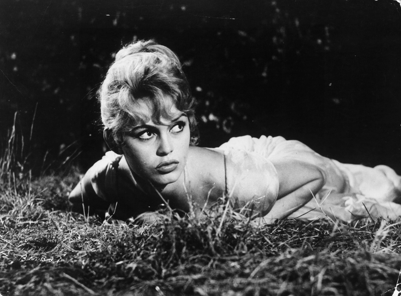 Brigitte Bardot laying in the grass in a scene from the film &#039;The Bride is Much Too Beautiful&#039;, 1956. (Photo by S.N. Pathe Cinema/Getty Images)