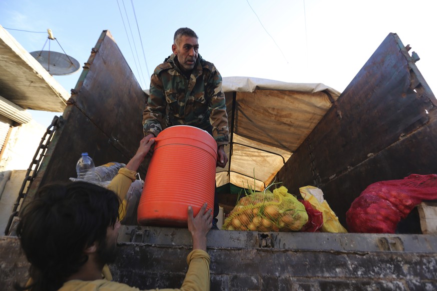 Food is loaded onto a truck as civilians flee Maaret al-Numan, Syria, ahead of a government offensive Sunday, Dec. 22, 2019. Syrian government forces pushed deeper in their offensive on the last remai ...