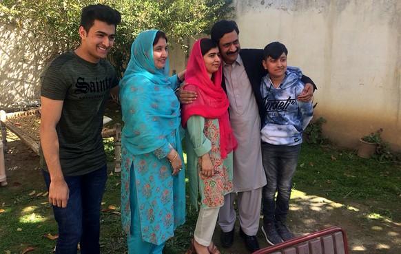 Pakistan&#039;s Nobel Peace Prize winner Malala Yousafzai, center, poses for a photograph with her family members at her native home during a visit to Mingora, the main town of Pakistan Swat Valley, S ...