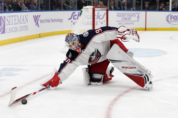 Columbus Blue Jackets goaltender Elvis Merzlikins (90), of Latvia, reaches for a loose puck during the second period of an NHL hockey game against the St. Louis Blues on Friday, Nov. 1, 2019, in St. L ...