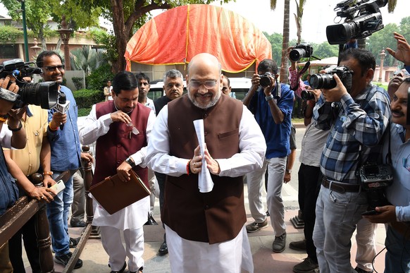 epa07757402 Indian Home Minister Amit Shah (C) arrives at Parliament House prior to his address to both Houses of Parliament following a cabinet meeting at Prime Minster Narendra ModiÄôs residence in ...