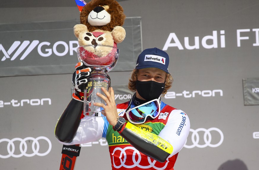 Switzerland&#039;s Marco Odermatt celebrates on the podium after winning an alpine ski, World Cup men&#039;s giant slalom in Kranjska Gora, Slovenia, Saturday, March 13, 2021. (AP Photo/Marco Trovati)