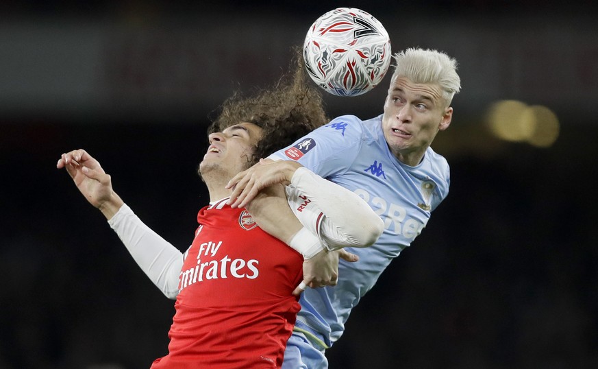 Arsenal&#039;s Matteo Guendouzi, left, and Leeds United&#039;s Ezgjan Alioski challenge for the ball during the English FA Cup soccer match between Arsenal and Leeds United at the Emirates Stadium in  ...