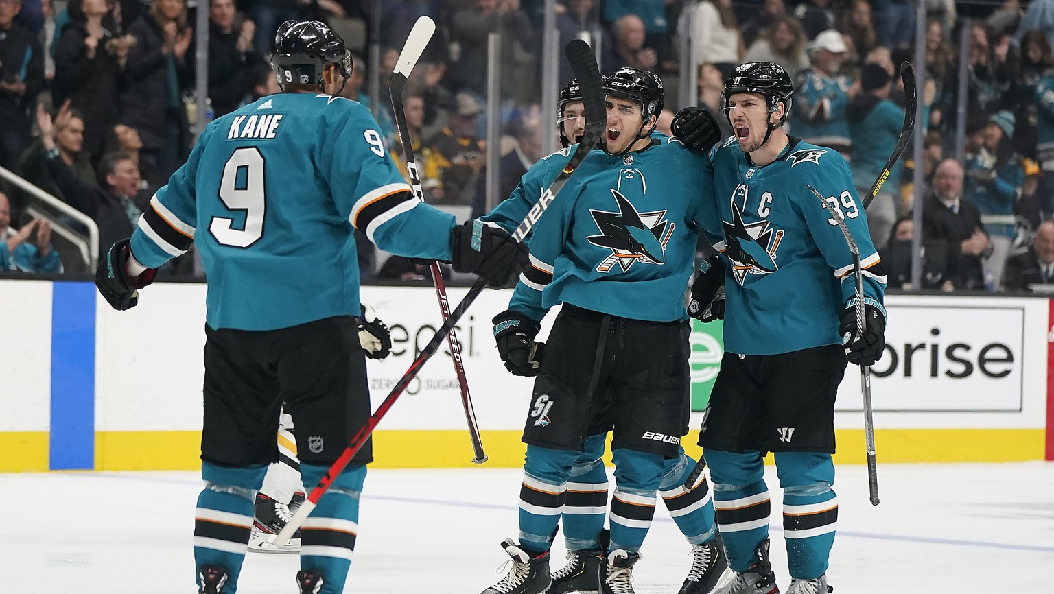 San Jose Sharks center Logan Couture (39) celebrates with teammates Evander Kane (9) and Timo Meier, center, after scoring a goal against the Pittsburgh Penguins during the third period of an NHL hock ...