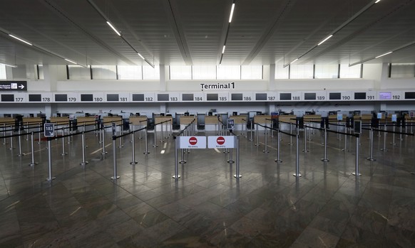 A view of closed check in counters at Vienna&#039;s Schwechat airport, Austria, Monday, March 23, 2020. For most people the coronavirus causes mild or moderate symptoms, such as fever and cough, but f ...