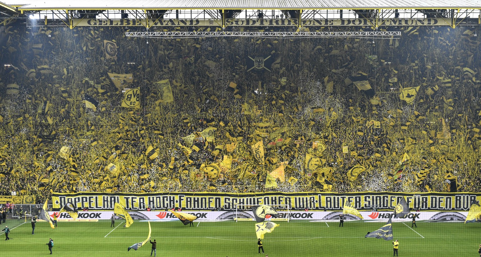 FILE - In this April 13, 2019 file photo, Borussia Dortmund&#039;s fans celebrate on the famous south tribune &#039;Gelbe Wand&#039;, the largest terrace for 24,454 standing spectators in European foo ...