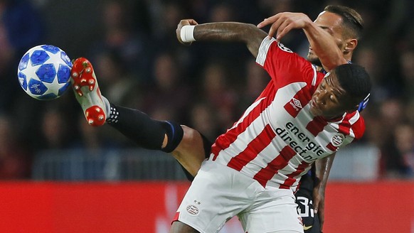 Inter defender Danilo D&#039;Ambrosio, rear, clears the ball before PSV&#039;s Steven Bergwijn during a Group B Champions League soccer match between PSV and Inter Milan at the Philips stadium in Eind ...