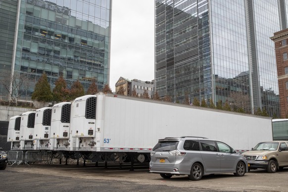 Refrigerated trailers are seen parked at the site of a makeshift morgue being built in New York, Wednesday, March 25, 2020. New York officials are keeping a close eye on already-stressed hospitals as  ...