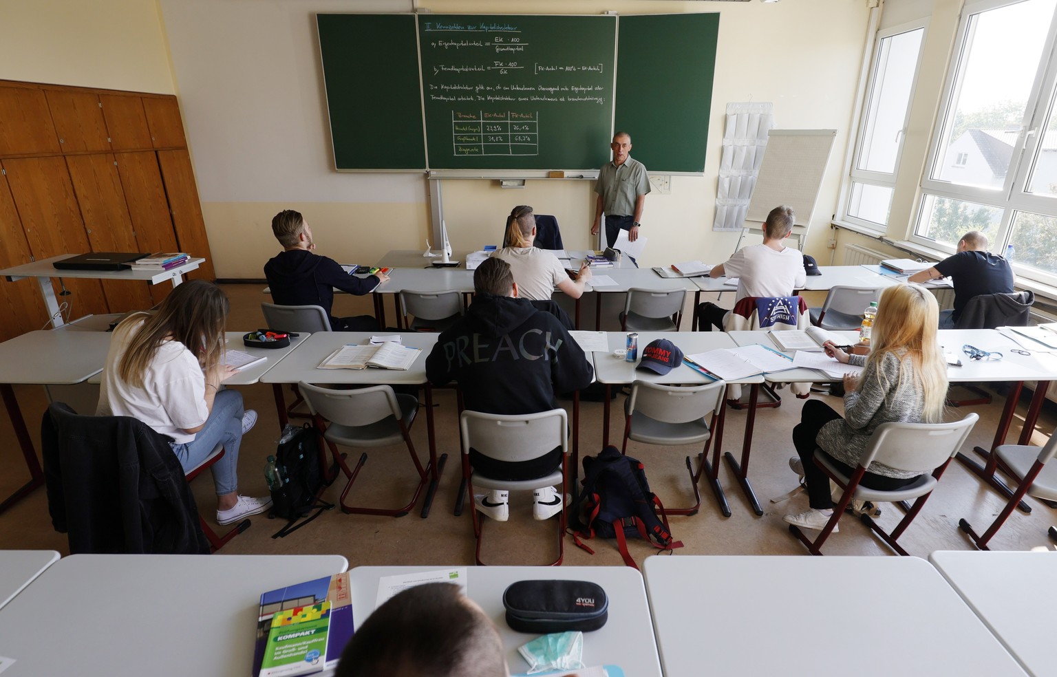 epa08385945 Vocational school students for wholesale merchants sit during a lesson at the Johann-Joachim-Becher vocational school in Speyer, Germany, 27 April 2020. On the day some school grades in Rh ...