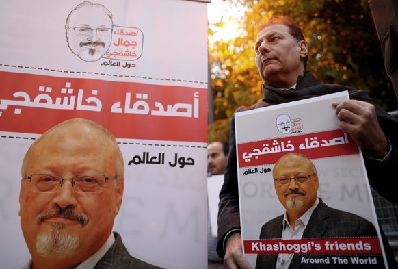 epa07119167 A man holds a picture of Jamal Khashoggi during the demonstration in front of Saudi Arabian consulate in Istanbul, Turkey, 25 October 2018. Turkish President Erdogan addressed the parliame ...