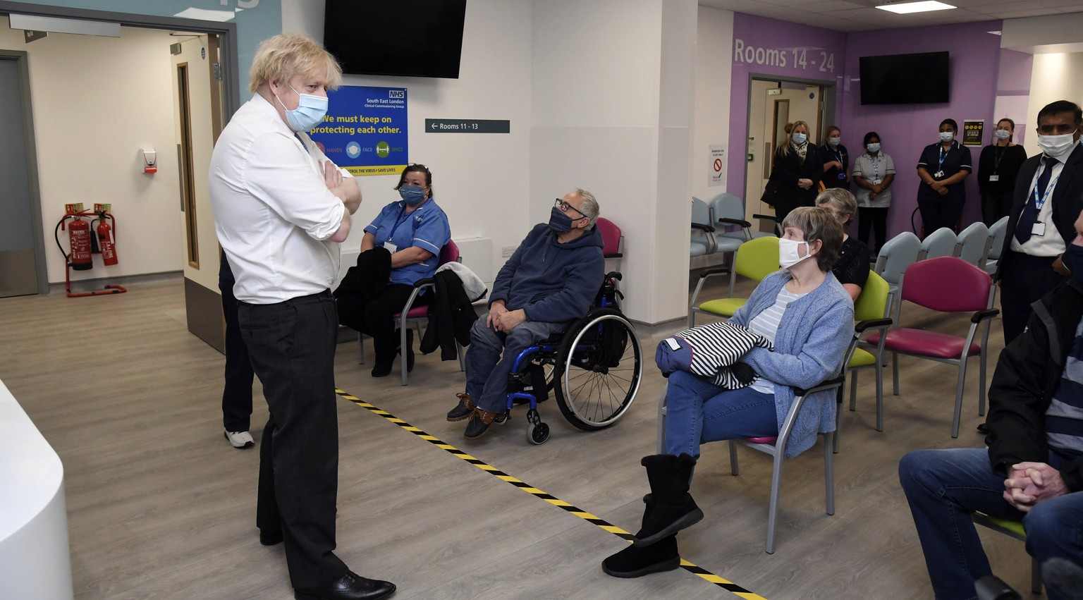 Britain&#039;s Prime Minister Boris Johnson meets people waiting for their vaccine during a visit to a coronavirus vaccination centre at the Health and Well-being Centre in Orpington, south-east Londo ...