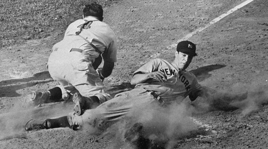 FILE -- Joe DiMaggio, New York Yankee outfielder, slides safely into the plate with the run which tied the score in the ninth inning of the fourth and final game of the World Series at Crosley Field i ...