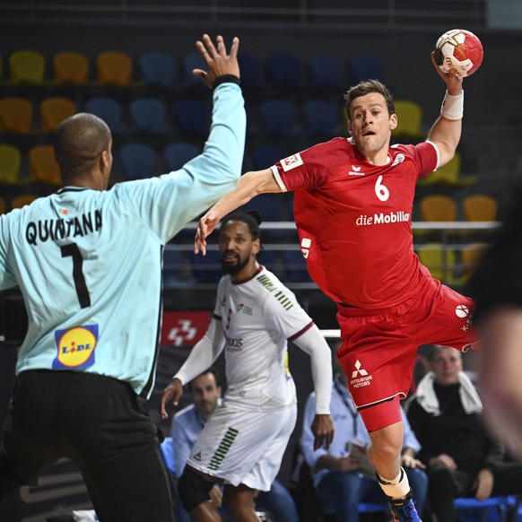 Switzerland&#039;s Cedrie Tynowski shoots as Portugal&#039;s Alfredo Quintana in position during the World Handball Championship between Switzerland and Portugal in Cairo, Egypt, Friday, Jan. 22, 2021 ...
