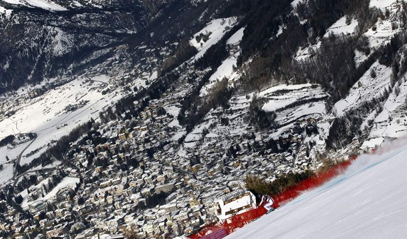 A view of alpine ski resort town of Bormio, northern Italy, as Yannick Bertrand of France, off-center right at bottom midground, speeds down the slope in the alpine ski Men&#039;s World Cup Downhill r ...