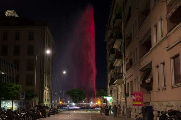 In this image made with a long time exposure the famous water fountain Le Jet d&#039;Eau is illuminated in the red to mark the dramatic situation in the event industry due to the coronavirus COVID-19  ...