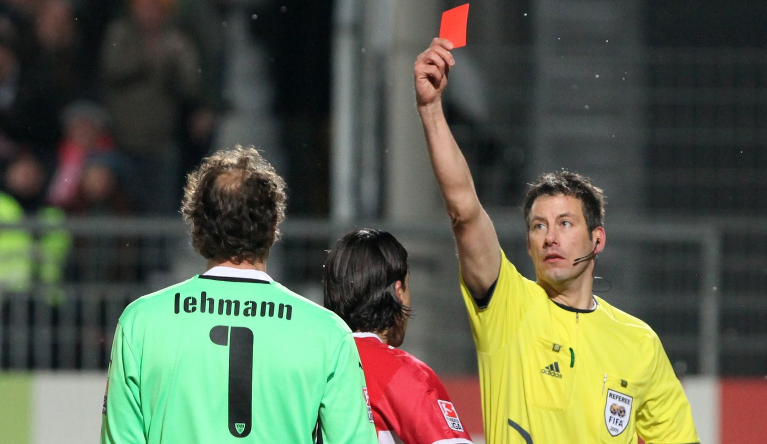 In this picture taken Dec. 13, 2009 referee Wolfgang Stark, right, shows a red card to former national goalie and Stuttgart&#039;s keeper Jens Lehmann, left, after tackling Aristide Bance, not in the  ...
