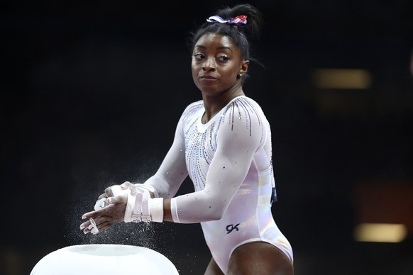 FILE - In this Oct. 10, 2019, file photo, Simone Biles of the United States gets ready to perform on the uneven bars in the women&#039;s all-around final at the Gymnastics World Championships in Stutt ...