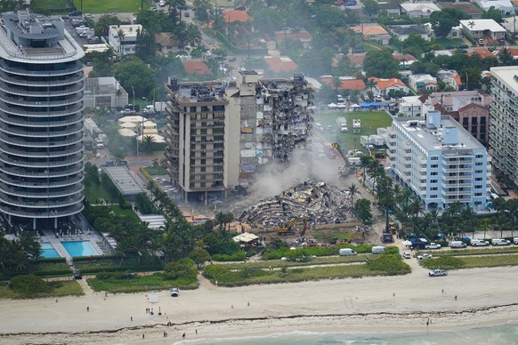 FILE - In this Friday, June 25, 2021, file photo, rescue personnel work in the rubble at the Champlain Towers South Condo, in Surfside, Fla. Even as the search continues over a week later for signs of ...