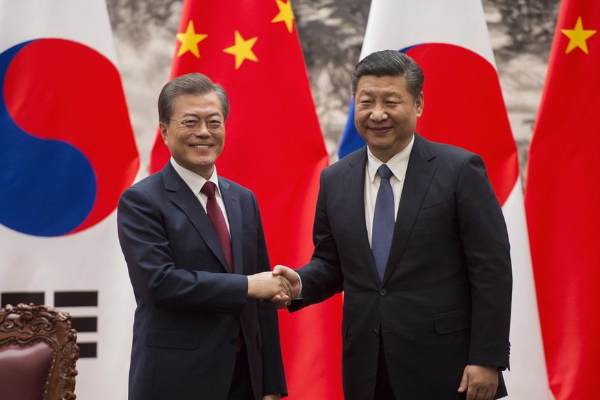 FILE - In this Dec. 14, 2017, file photo, South Korean President Moon Jae-in, left, and Chinese President Xi Jinping pose for a photo at the end of a signing ceremony at the Great Hall of the People i ...