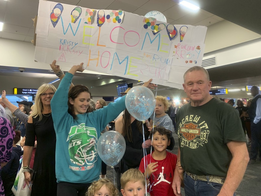 Danny Mather, right, and other family members wait at the Wellington International Airport for the arrival of Mather&#039;s pregnant daughter Kristy in Wellington, New Zealand Monday, April 19, 2021.  ...
