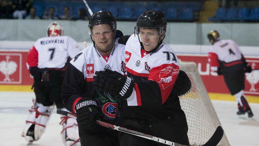 Player of HC Fribourg-Gotteron Ralph Stalder, left, and player of HC Fribourg-Gotteron Killian Mottet, right, react after the first goal (1-0) for HC Fribourg-Gotteron, during the Champions Hockey Lea ...