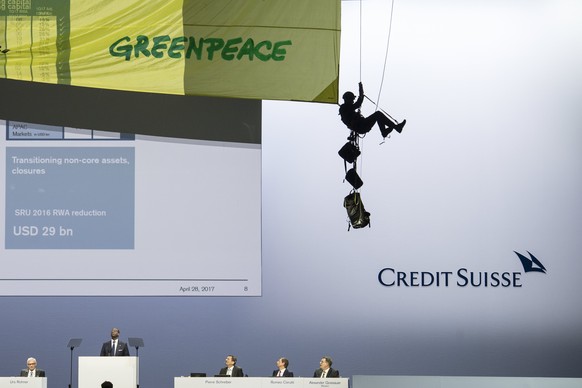 epa05932367 A Greenpeace activist abseils from the ceiling during the Credit Suisse (CS) general assembly in protest against the bank&#039;s pipline deals, at the Hallenstadion in Zurich, Switzerland, ...