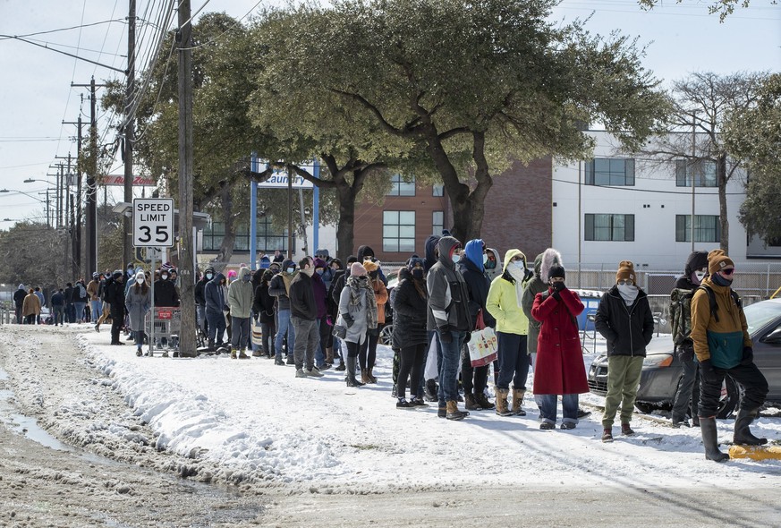 People wait in a long line to buy groceries at H-E-B on South Congress Avenue during an extreme cold snap and widespread power outage on Tuesday, Feb. 16, 2021, in Austin, Texas. (Jay Janner/Austin Am ...