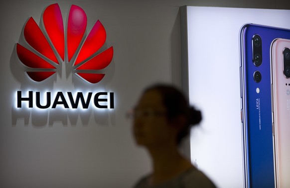 FILE - In this July 4, 2018, file photo, a shopper walks past a Huawei store at a shopping mall in Beijing. Chinese telecom equipment giant Huawei unveiled Monday, Jan. 7, 2019, a processor chip for d ...