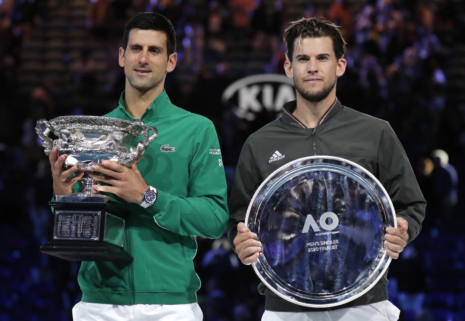 Serbia&#039;s Novak Djokovic, left, holds the Norman Brooks Challenge Cup after defeating Austria&#039;s Dominic Thiem in the men&#039;s singles final of the Australian Open tennis championship in Mel ...