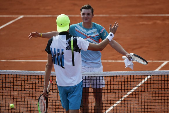 Switzerland&#039;s Dominic Stephan Stricker, right, is congratulated by Switzerland&#039;s Leandro Riedi after Stricker won the junior men&#039;s final match of the French Open tennis tournament at th ...