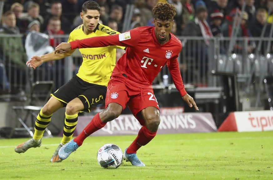 Bayern&#039;s Kingsley Coman, right, duels for the ball with Dortmund&#039;s Achraf Hakimi during the German Bundesliga soccer match between FC Bayern Munich and Borussia Dortmund, in Munich, Germany, ...