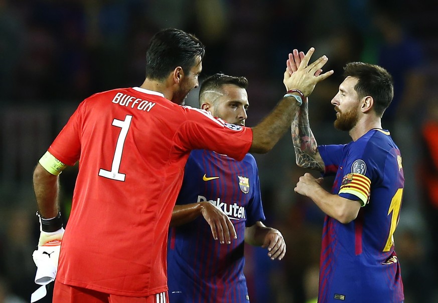 Barcelona&#039;s Lionel Messi shakes hands with Juventus goalkeeper Gianluigi Buffon at the end of a group D Champions League soccer match between FC Barcelona and Juventus at the Camp Nou stadium in  ...