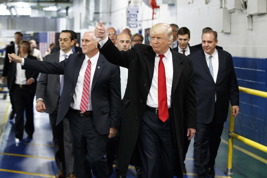 FILE - In this Thursday, Dec. 1, 2016 file photo, President-elect Donald Trump and Vice President-elect Mike Pence wave as they visit to Carrier factory, in Indianapolis, Ind. Trump is slamming a unio ...