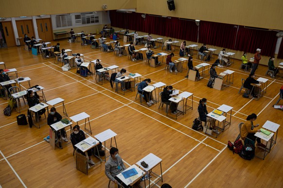 epa08380986 Students sit for the Diploma of Secondary Education (DSE) exams in Hong Kong, China, 24 April 2020. Temperature checks and social distancing measures to avoid the spread of COVID-19 have b ...