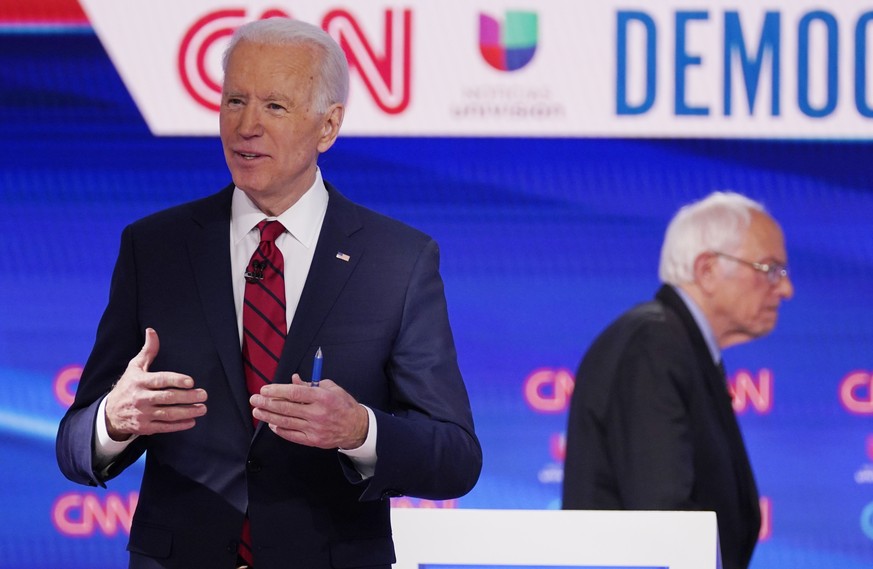 Sen. Bernie Sanders, I-Vt., right, and former Vice President Joe Biden, left, return to the stage after a commercial break in a Democratic presidential primary debate at CNN Studios, Sunday, March 15, ...