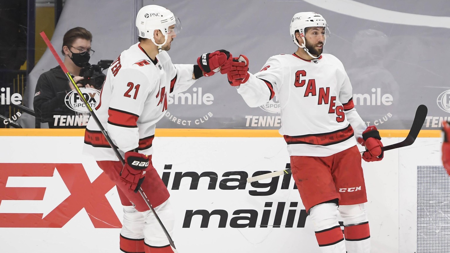January 18, 2021, Carolina Hurricanes right wing Nino Niederreiter 21 celebrates the goal of center Vincent Trocheck 16 against the Nashville Predators during the third period between the Carolina Hur ...