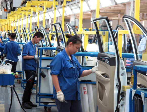 Employees work at a production line inside a factory of Saic GM Wuling, in Liuzhou, Guangxi Zhuang Autonomous Region, China, June 19, 2016. REUTERS/Norihiko Shirouzu