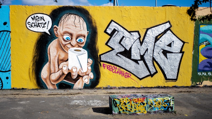 A graffiti depicting the character of Gollum from &quot;Lord of the Rings,&quot; holding a roll of toilet paper and saying &quot;My precious,&quot; is painted on a wall in the Mauerpark public park at ...