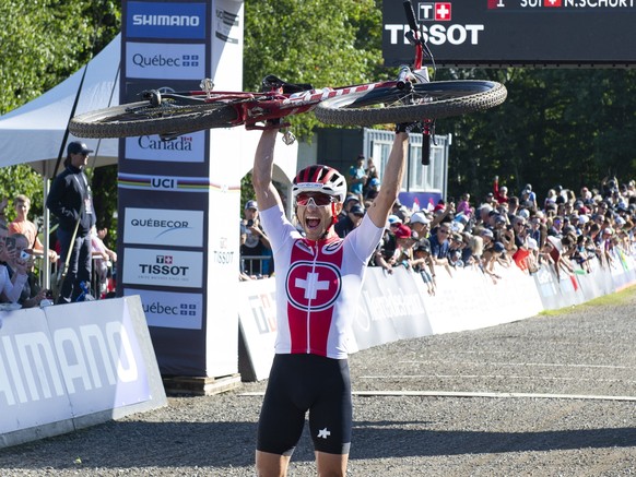 Nino Schurter of Switzerland celebrates his victory after he crossed the finish line in the men&#039;s elite XC mountain bike world championships Saturday, Aug. 31, 2019 at Mont-Sainte-Anne in Beaupre ...