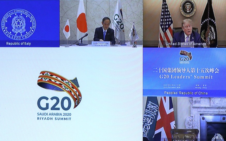 epa08832944 Japan&#039;s Prime Minister Yoshihide Suga and U.S. President Donald Trump are seen on a screen before the start of the virtual G20 meeting hosted by Saudi Arabia, amid the coronavirus dis ...