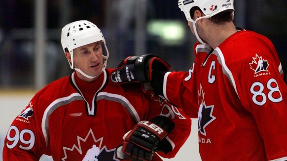 Team Canada&#039;s Wayne Gretzky, left, is congratulated by teammate Eric Lindros, right after Canada defeated the U.S. Olympic hockey team 4-1 at the Big Hat arena in Nagano Monday, Feb. 16, 1998. (K ...